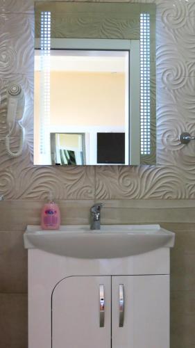a bathroom with a sink and a mirror at Villa Angelos in Ohrid