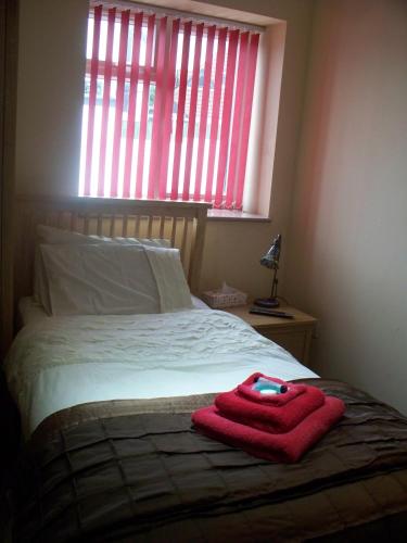 a bedroom with a bed with a red towel on it at The Horseshoe in Bristol