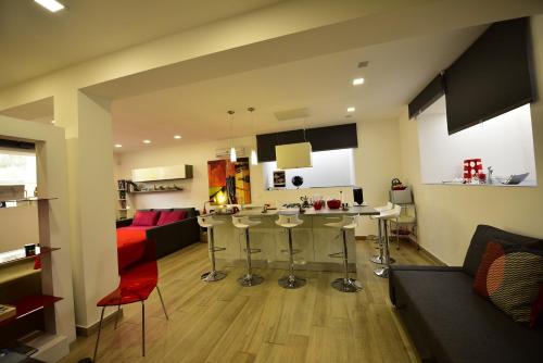 a kitchen and living room with a couch and a table at Folco Studio Apartment in Piazza Armerina