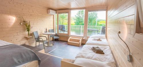 a room with two beds and a table and a window at Hausboaty Ypsilon Golf Liberec in Fojtka