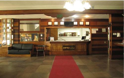 sala de estar con sofá y alfombra roja en Hotel Portal, en Santana do Livramento