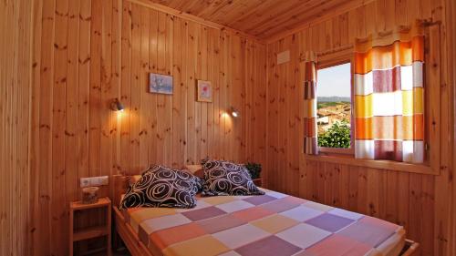 
a bedroom with a bed and a window at Serra de Prades Resort in Vilanova de Prades
