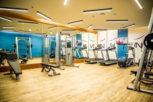 a gym with treadmills and cardio equipment in a room at Novotel Yanbu Albahr in Yanbu