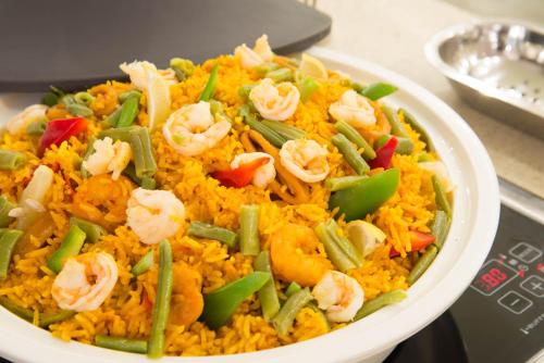 a plate of food with shrimp and rice at Novotel Yanbu Albahr in Yanbu
