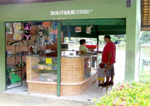 a man standing in front of a food stand at Resort Hotel Atlantic City Nautico Club in Teresina