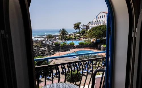 a view of the beach from a room with a window at Hotel Nike in Giardini Naxos