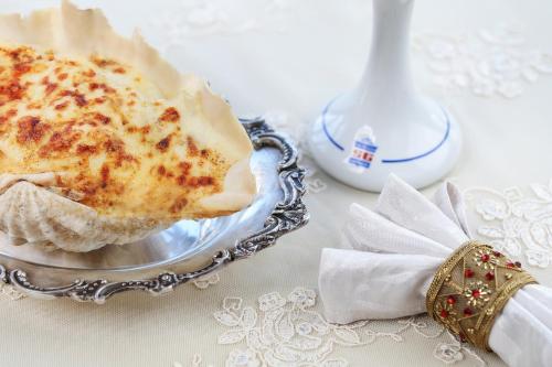 a piece of cake on a plate on a table at San Giovanni Stanly Hotel in Alexandria