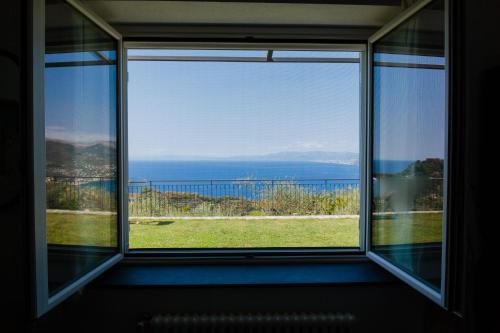 una finestra con vista sull'oceano da una casa di Villa Paradiso a Camogli