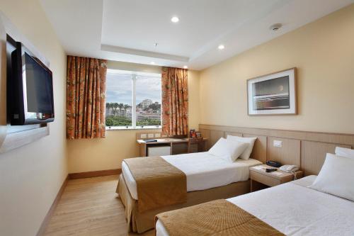 
A bed or beds in a room at Windsor Flórida

