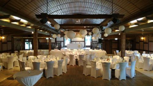 a banquet hall with white tables and white chairs at Gasthof Tepferdt in Rees