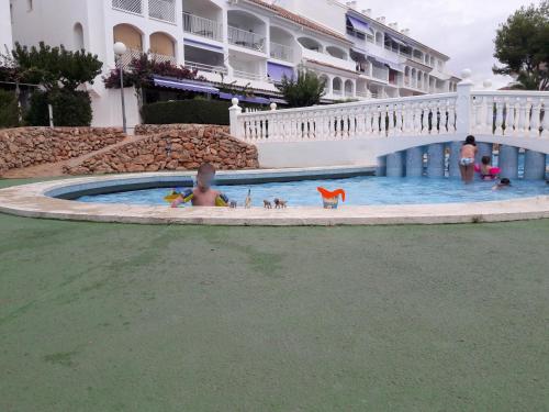 a child in a swimming pool at a resort at APCOSTAS - Complejo Al Andalus in Alcossebre