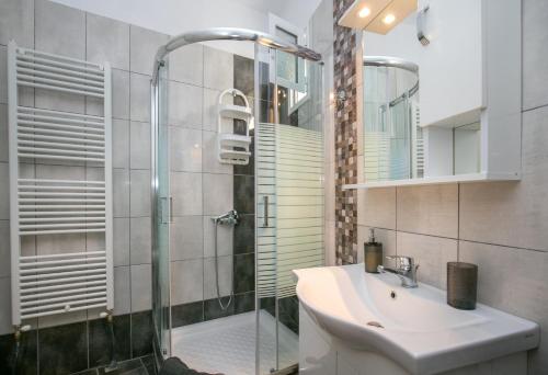 a bathroom with a glass shower and a sink at Casa Del Sol in Skala Marion