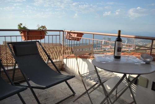 a bottle of wine sitting on a table on a balcony at Bed & Breakfast StudioArcodia- in San Marco dʼAlunzio