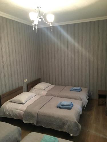 a bedroom with two beds with towels on them at Cherry in Stepantsminda