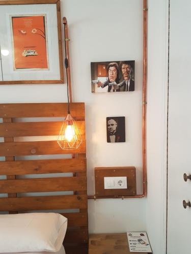 una camera con una scala con immagini appese al muro di Barri Antic Hostel & Pub ad Andorra la Vella