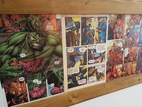 a wall covered in marvel comics at Barri Antic Hostel & Pub in Andorra la Vella