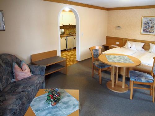a hotel room with a bed and a living room at Giglerhof in Bad Birnbach
