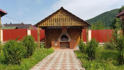 a large wooden building with a door in a yard at Lara in Solochin