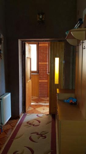 a kitchen with a door leading to a hallway at Lara in Solochin