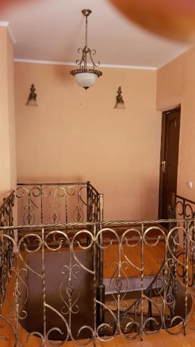 a metal bed in a room with a chandelier at Lara in Solochin