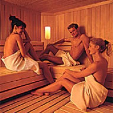 three naked people sitting on beds in a room at Hotel Omesberg in Lech am Arlberg