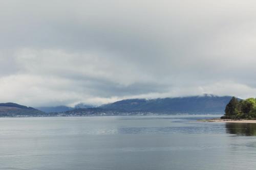 a large body of water with mountains in the background at The Inverkip Restaurant, Bar & Hotel in Inverkip