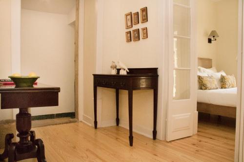a room with a bed and a table with a stuffed animal on it at Casa Holstein Quinta de Sao Sebastiao Sintra in Sintra