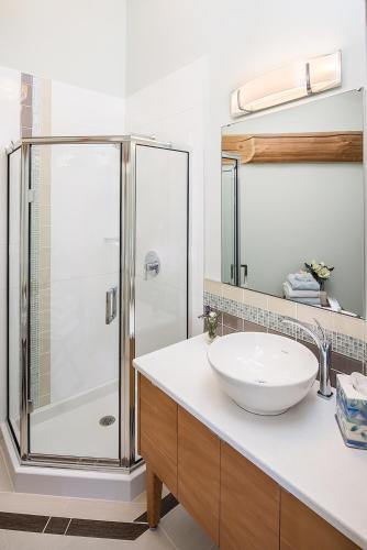 a bathroom with a sink and a shower at The Rockwell-Harrison Guest Lodge in Harrison Hot Springs