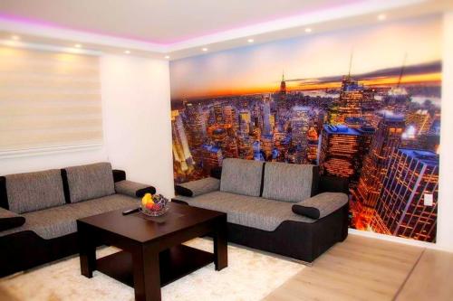 a living room with a large painting of a city at Istočno Sarajevo in Sarajevo