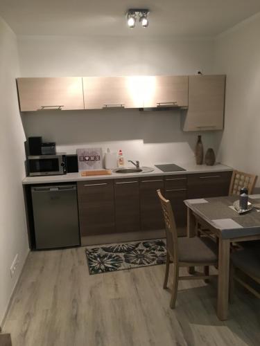 a kitchen with a table and a stove and a counter top at Apartament JULIA in Świnoujście