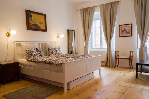 a bedroom with a white bed and a window at B&B Krumlov in Český Krumlov