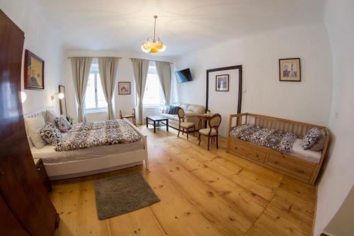 a bedroom with two beds and a living room at B&B Krumlov in Český Krumlov