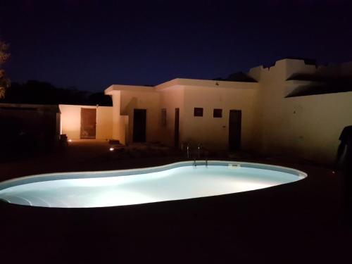 a bath tub in front of a house at night at Villa Du Soleil Ngaparou in Ngaparou