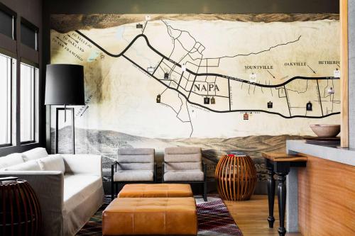 a living room with a map mural on the wall at Andaz Napa - a concept by Hyatt in Napa
