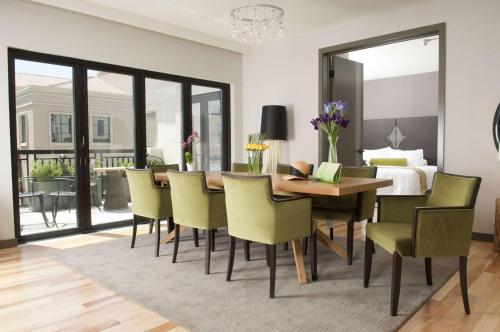 a dining room with a table and chairs and a bed at Andaz Napa, By Hyatt in Napa