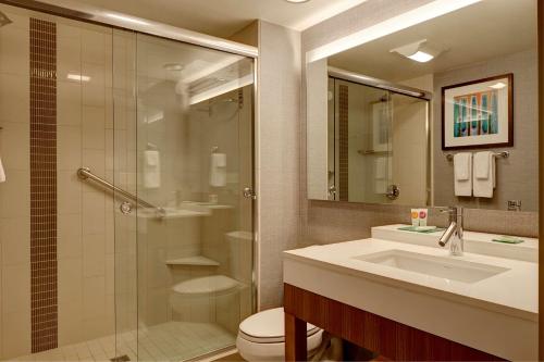 a bathroom with a shower and a sink and a toilet at Hyatt Place Columbus in Columbus