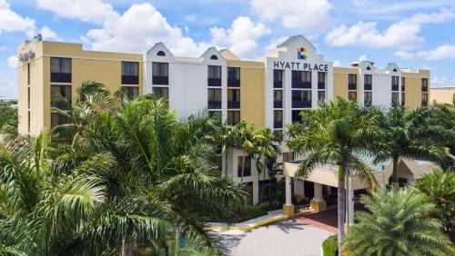 a hotel with palm trees in front of it at Hyatt Place Fort Lauderdale Cruise Port & Convention Center in Fort Lauderdale