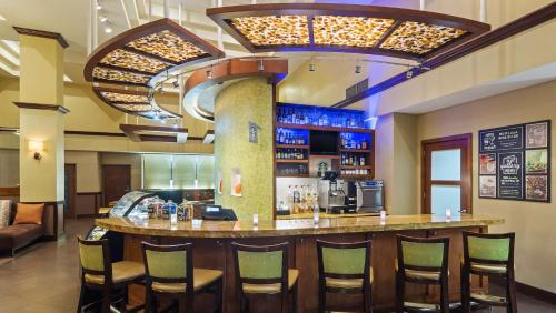 a bar in a restaurant with chairs around it at Hyatt Place Fort Lauderdale Cruise Port & Convention Center in Fort Lauderdale