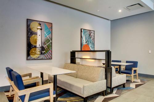 a dining room with tables and chairs and a picture of a lighthouse at Hyatt House Chicago/Evanston in Evanston