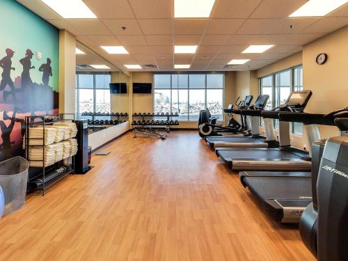 a gym with a row of treadmills and machines at Hyatt Place Edmonton West in Edmonton