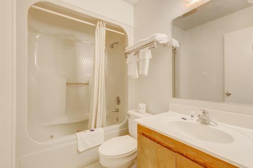 a white bathroom with a toilet and a sink at Lake View Inn in Granbury