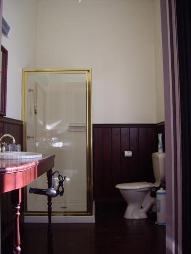 a bathroom with a glass shower and a toilet at Lucinda B&B in Latrobe