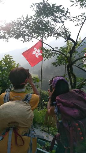 a group of people taking a picture of a flag at Experiencing Traditional Life Style Inn Kajiya Iya Romantei in Miyoshi