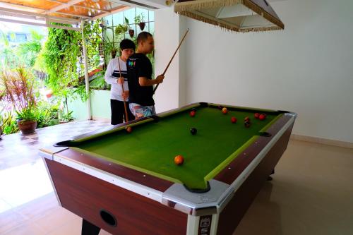 two people standing next to a pool table at Aonang Top View in Ao Nang Beach