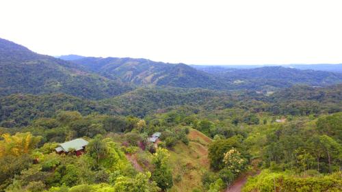 an aerial view of a mountain with a house on a hill at Santa Juana Lodge & Nature Reserve in Quepos
