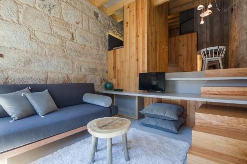 a living room with a blue couch and a table at Armazém Luxury Housing- Architectural & Design Hotel in Porto