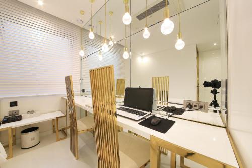 an office with a desk with a laptop computer on it at Hotel Cullinan 2 Geondae in Seoul