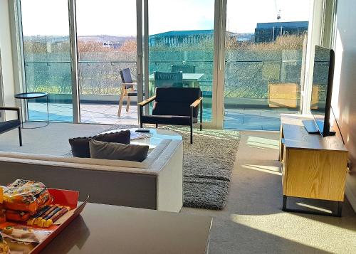 a living room with a couch and a table at Swiss-Belsuites Victoria Park Auckland in Auckland