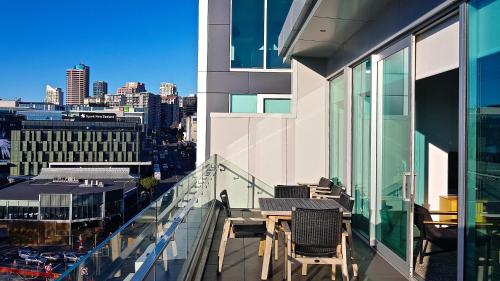 a balcony with a table and chairs on a building at Swiss-Belsuites Victoria Park Auckland in Auckland