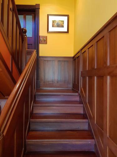 a staircase in a building with yellow walls at Bridgefield Guest House in Margaret River Town